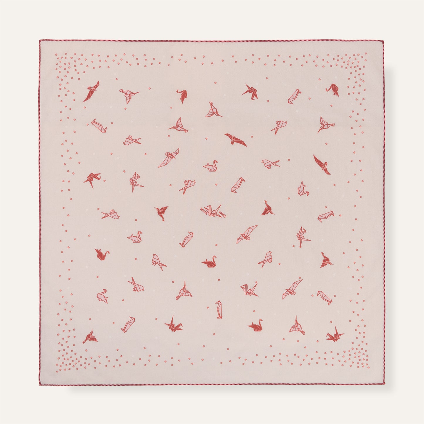 Pink fabric square with red pattern on a white background