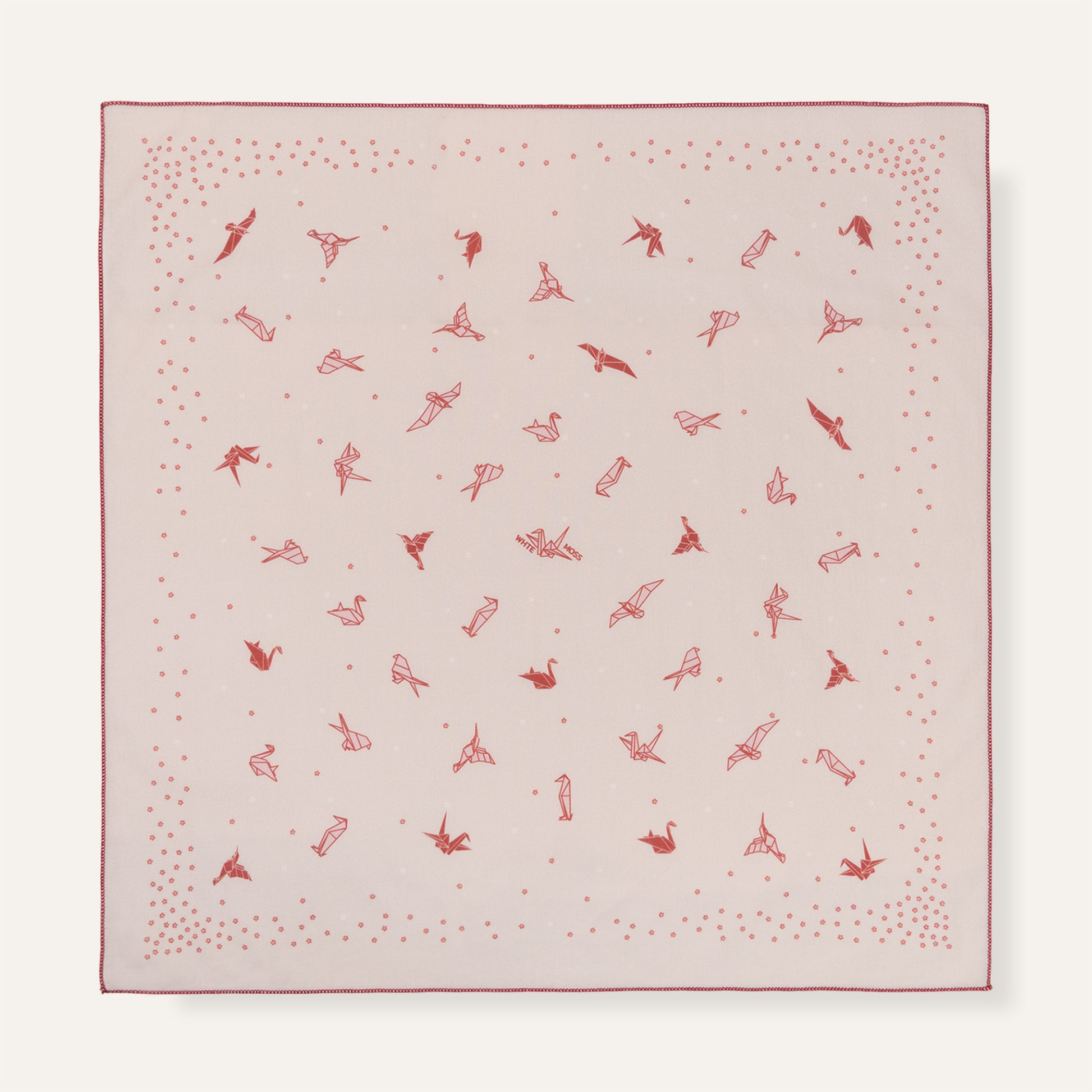 Pink fabric square with red pattern on a white background