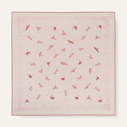 Pink fabric square with red pattern on a white background