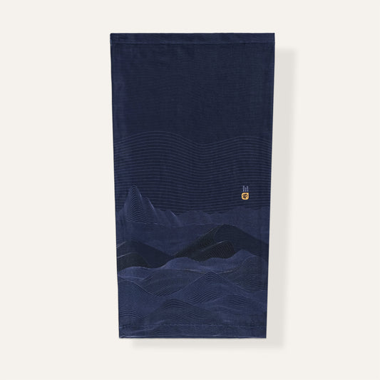 Navy blue neck gaiter with mountain design on a white background