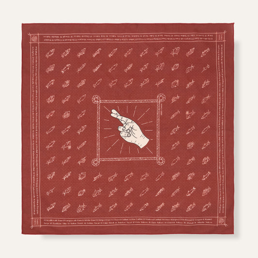 Red bandana with white patterns and central design on a white background