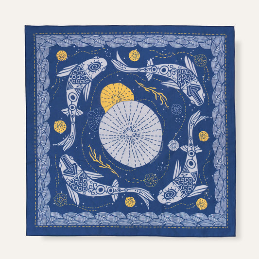 Decorative fabric square with fish and starburst design on a blue background