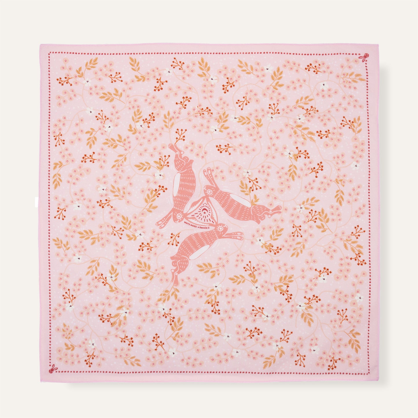 Pink fabric with floral patterns and a deer design on a white background