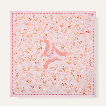 Pink fabric with floral patterns and a deer design on a white background