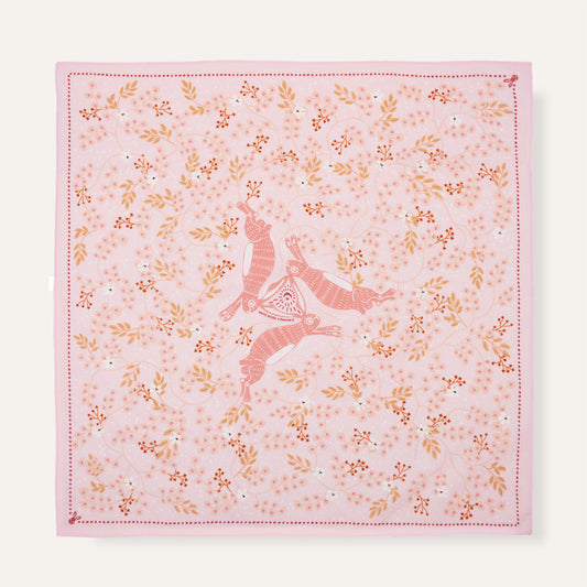 Pink fabric with floral patterns and a deer design on a white background